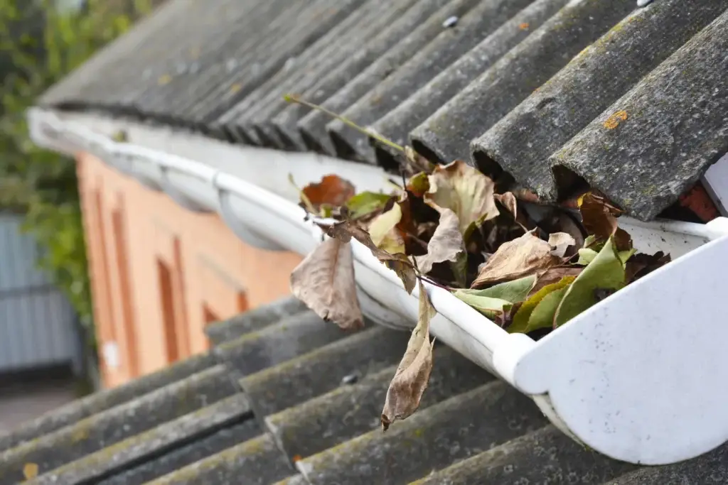 Dependable gutter cleaners removing debris to prevent damage to the roof and the foundation.
